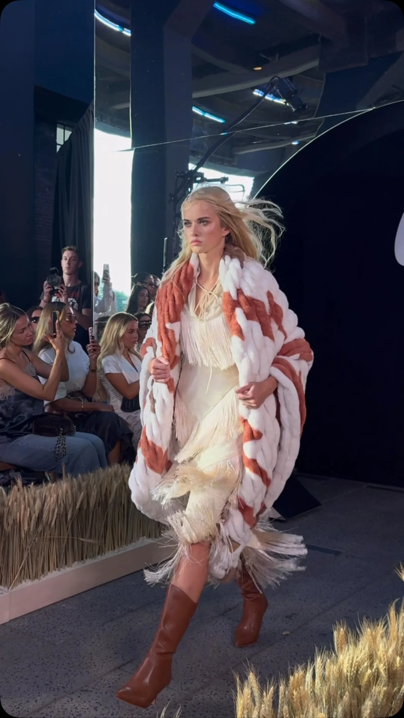 A model wearing a pink and white blanket in Lola Blankets’ WESTWARD runway show