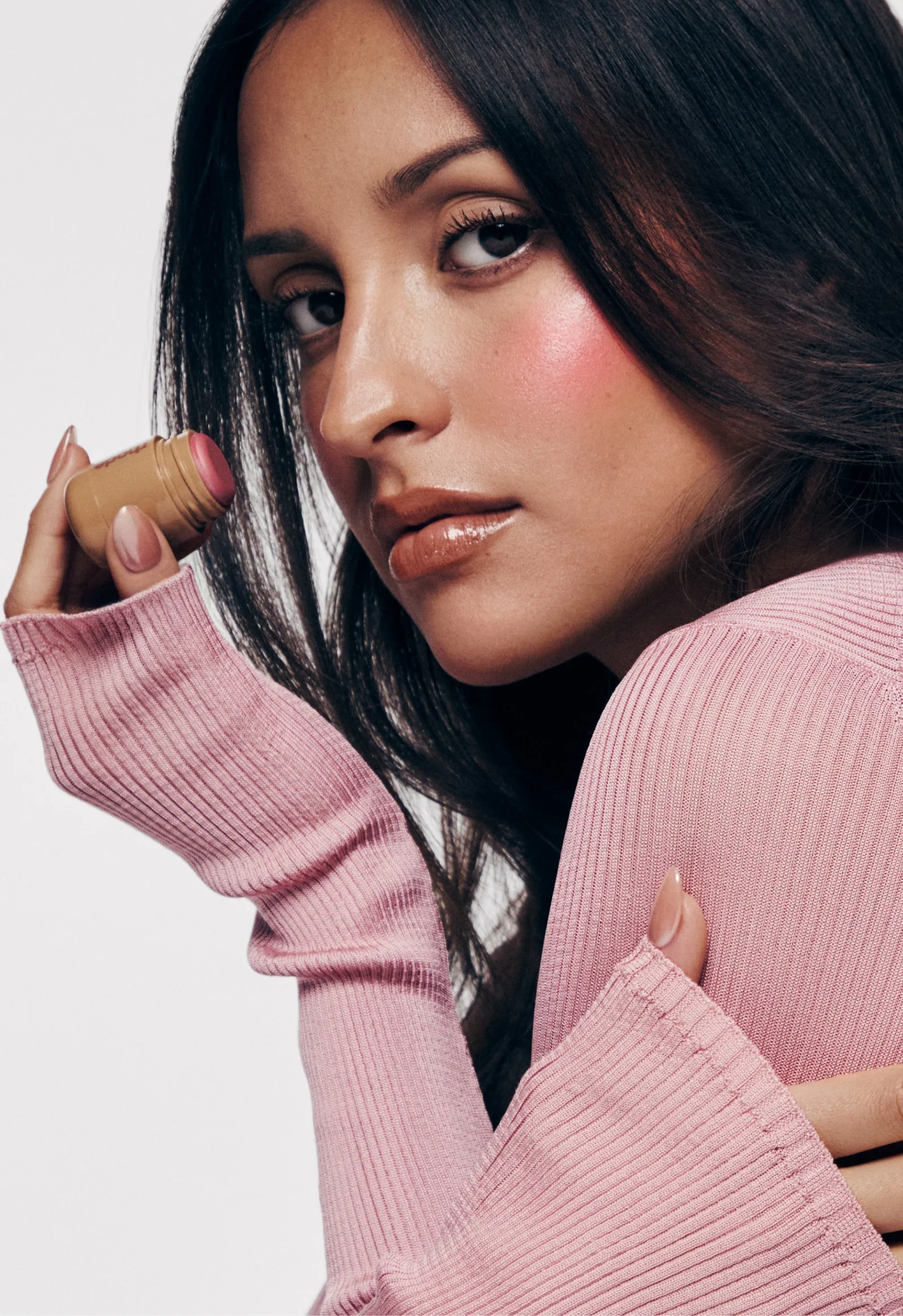 Alexandra Leclerc holding a miniature blush in Rhode’s collection campaign